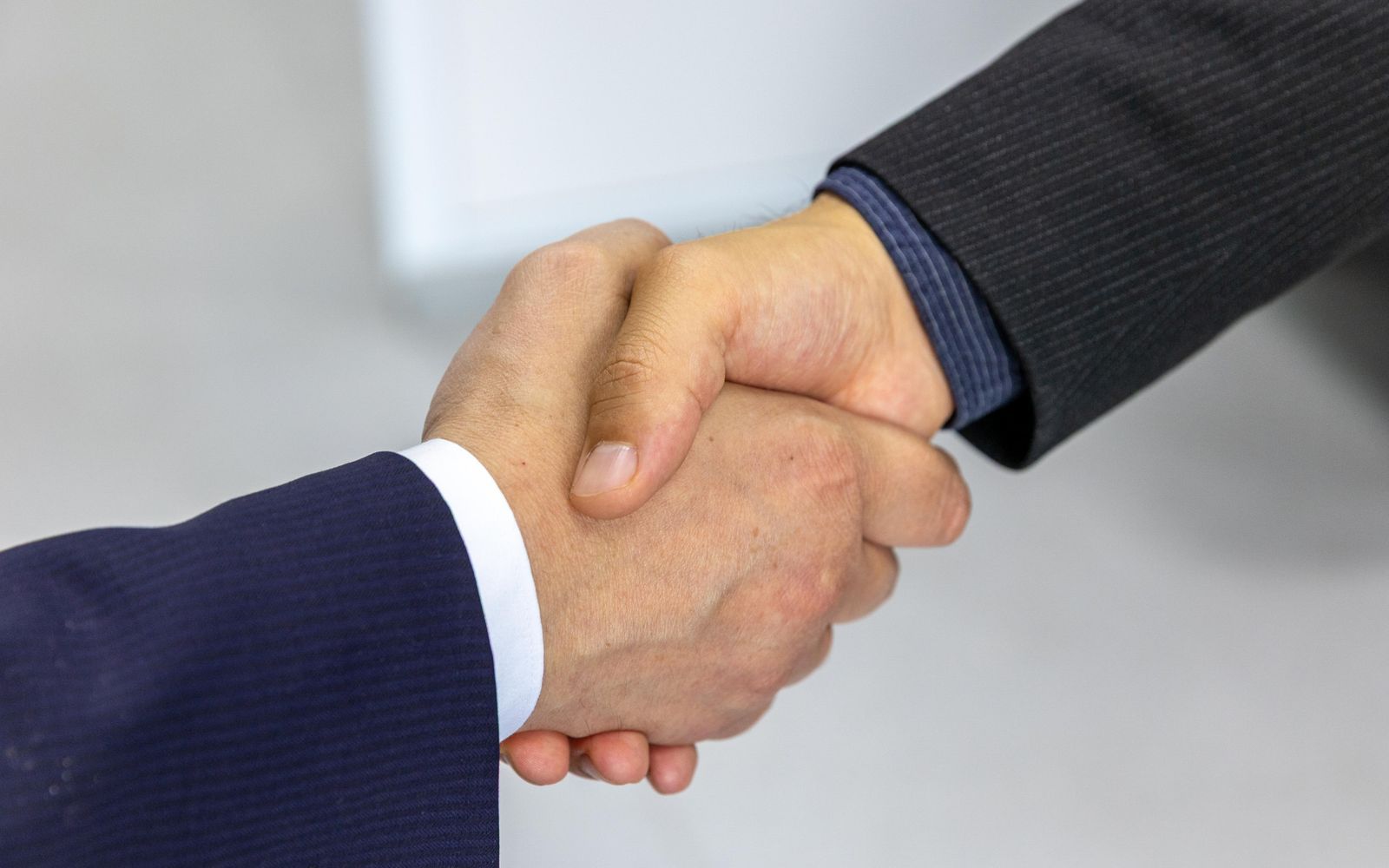 Close-up of two people shaking hands in agreement